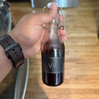 Two Maples Bourbon‑Aged Vanilla Extract 2 oz amber bottle.